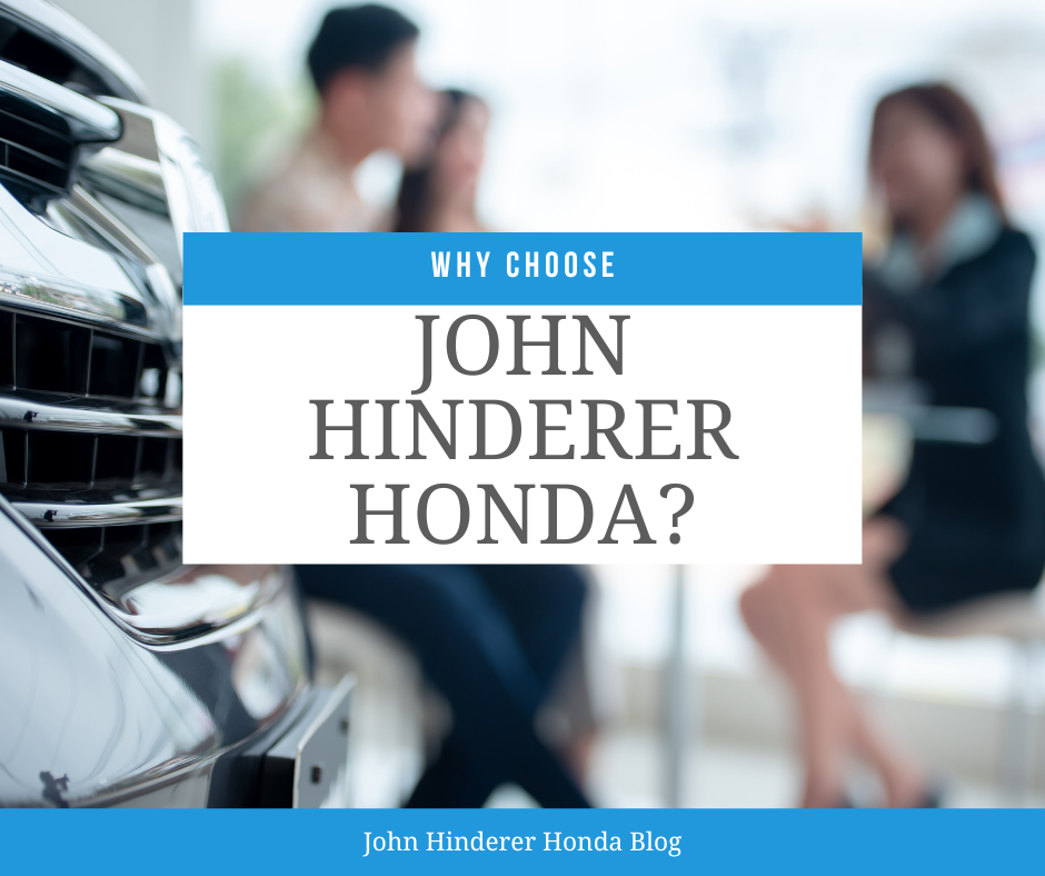 A couple buying a car at a car dealership and the text: Why Choose John Hinderer Honda?